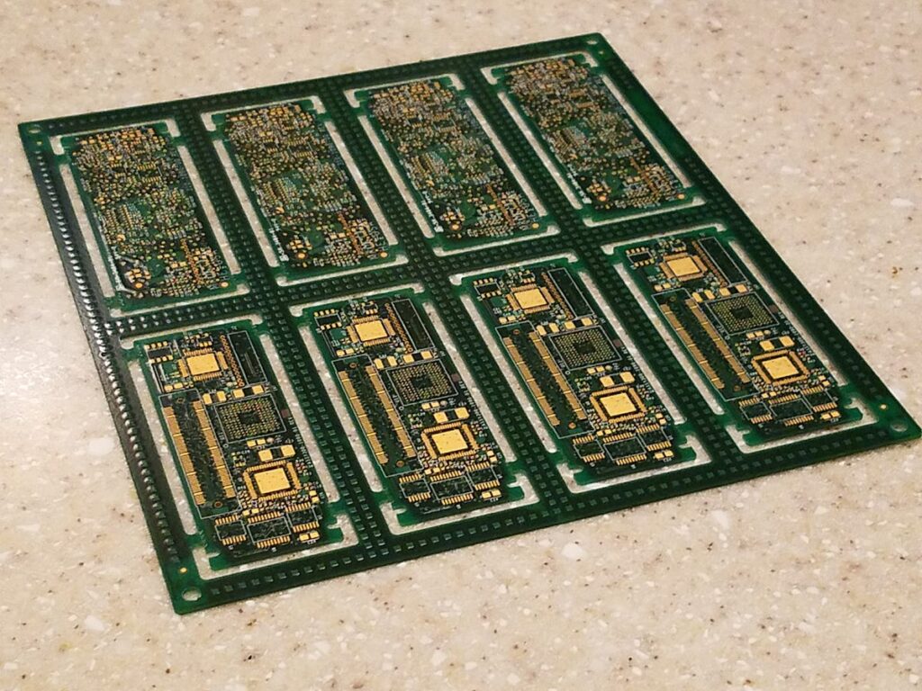 PCB assembly sub-panel showing multiple circuit boards joined by breakaway tabs and tooling rails